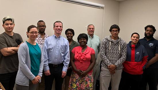 A group of participants from a fraud awareness workshop with 2 CSB Employees