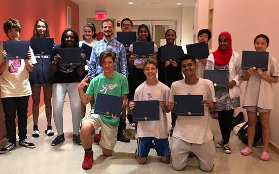 A group of students posing with certificates with CSB employee